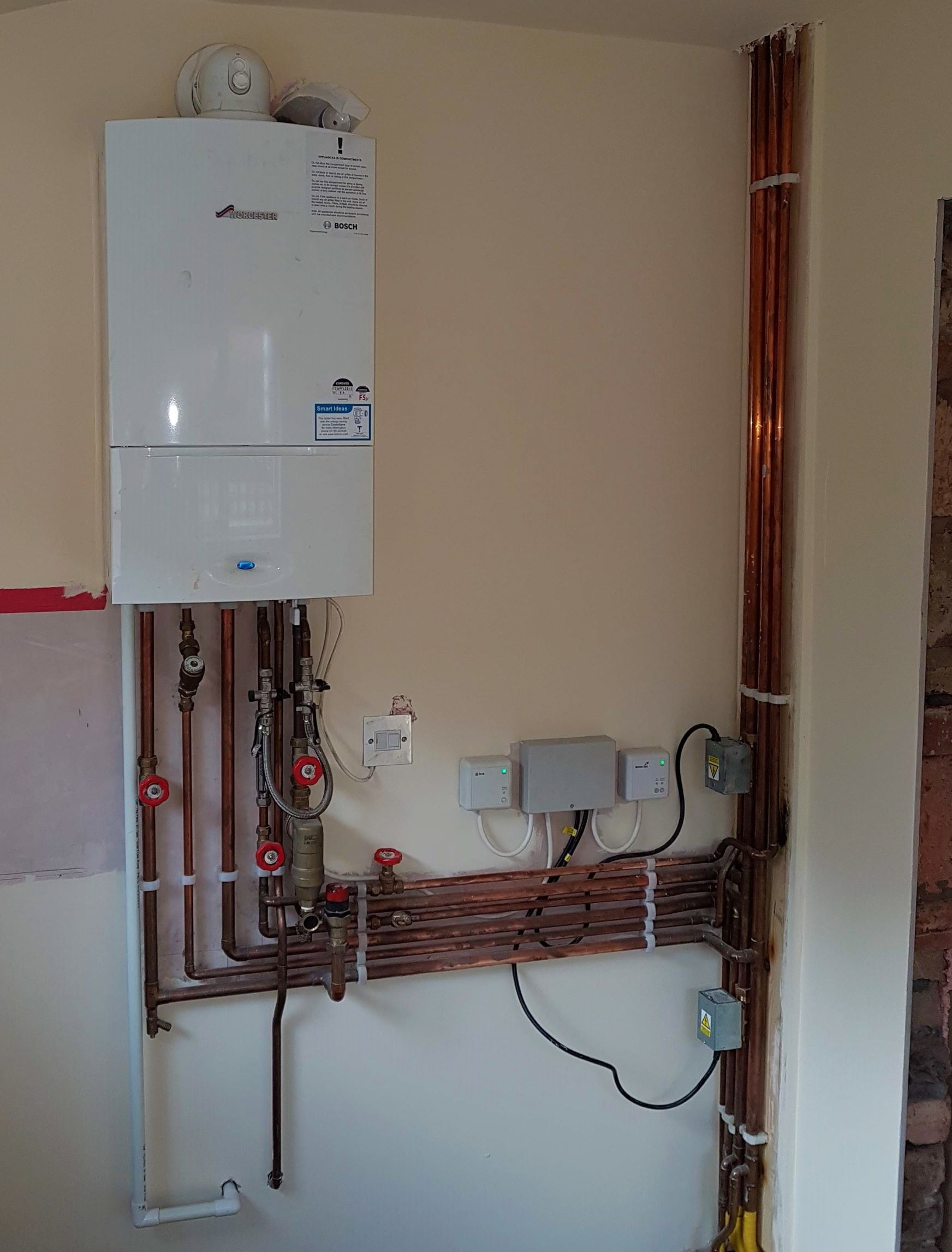 Boiler move and re-pipe following renovation work. System re-designed to include two zones, upstairs and downstairs. Wireless, independent control of zones.