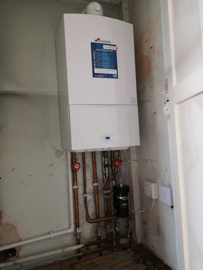 Boiler removed from kitchen and new boiler fitted in cylinder cupboard. System design altered as required.